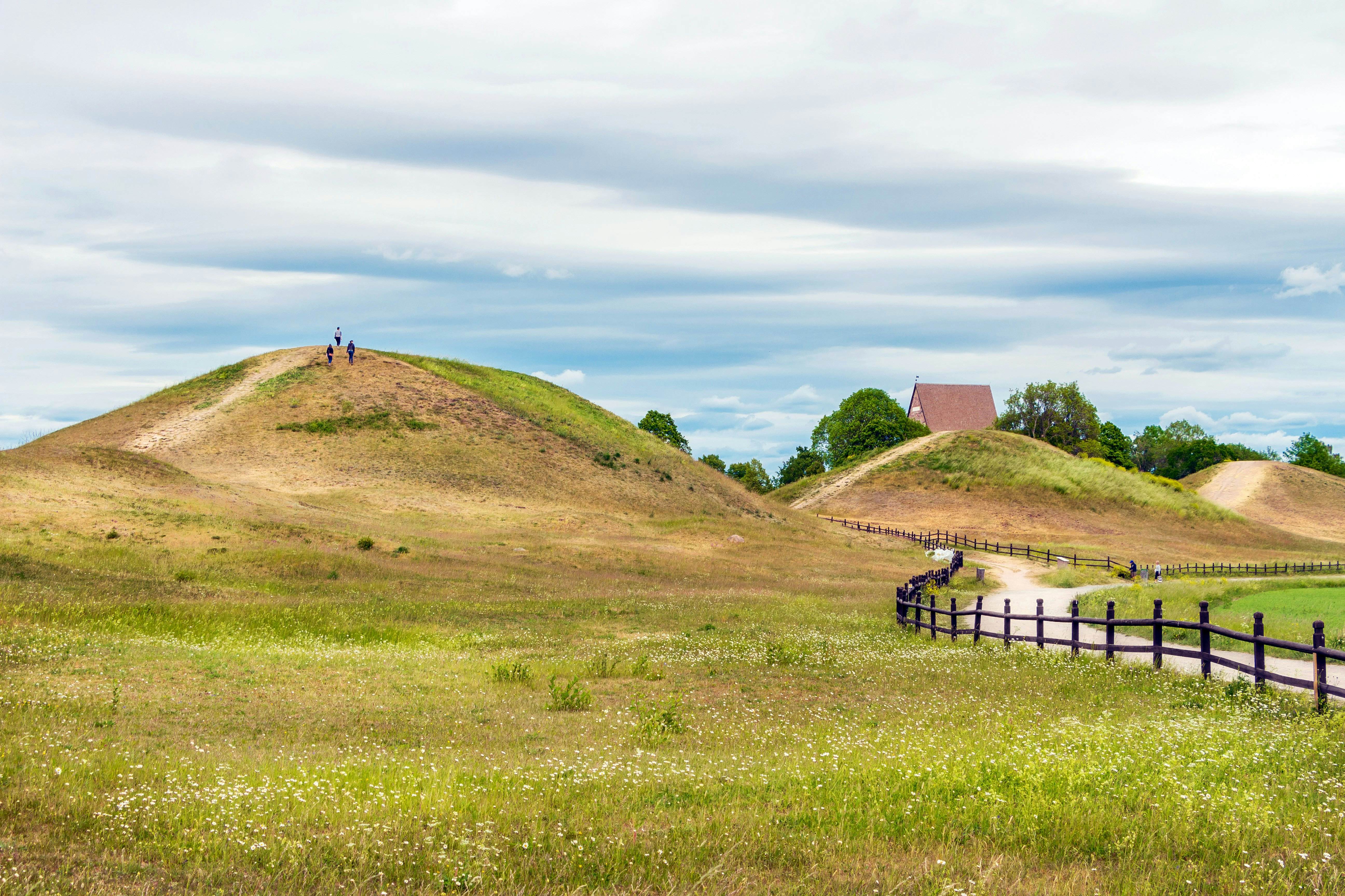 Royal Mounds - large barrows located in Gamla Uppsala village, Uppland, Sweden (70 km from Stockholm).  Beautiful Viking graves covered by grass. Gamla Uppsala is area rich in archaeological remains.; Shutterstock ID 1138429115; your: Bridget Brown; gl: 65050; netsuite: Online Editorial; full: POI Image Update
